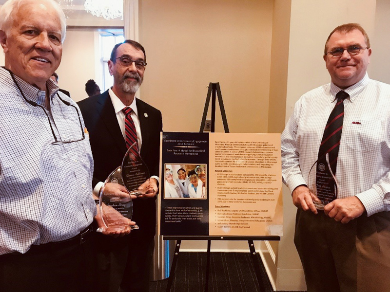 Base Pair was recognized at the University of Mississippi's 2019 Celebration of Service. Rockhold, center, was recognized along with Tim Medley, left, a Jackson-area accountant who proposed the the Base Pair idea and Jeff Stokes, right, lead teacher for Base Pair at Murrah High School.