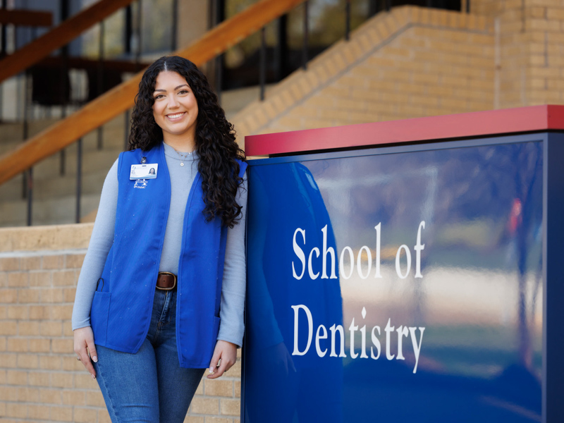 Volunteer Kelsi Mixon greets patients and visitors to the UMMC School of Dentistry.