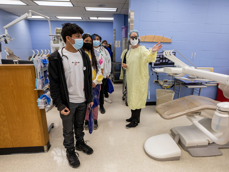 Dr. Elizabeth Carr, right, professor and chair of dental hygiene, describes for the students the features of a clinic in the School of Dentistry. Jay Ferchaud/ UMMC Communications
