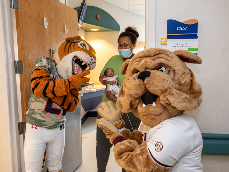 Children's of Mississippi patient Zoie Gray of Jackson and her mom, Chelsea Green got a visit from Sonny Thee Tiger of Jackson State University and Bully, the Mississippi State University mascot. Jay Ferchaud/ UMMC Communications
