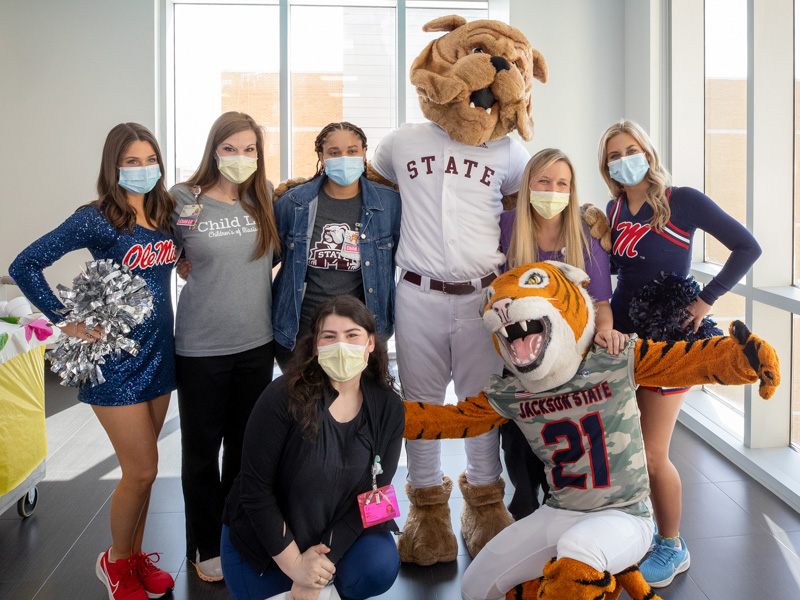 The dream team at Children's of Mississippi Saturday included, from left, Ole Miss dance team member Jane Granberry, child life specialist Cara Williams, child life assistant Erinn Funches, Bully, child life specialist Tiffany Key, Ole Miss cheerleader Mara Liston, and, kneeling,child life specialist Kelsey Clark and Sonny Thee Tiger. Jay Ferchaud/ UMMC Communications