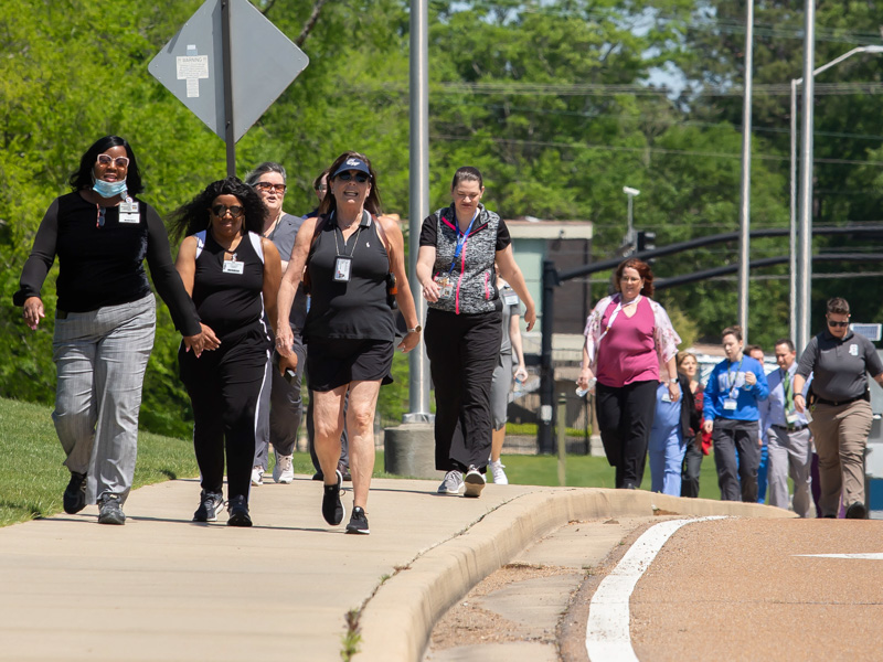 UMMC employees take a break from their duties for a walk around campus on National Walking Day Friday. Melanie Thortis/ UMMC Communications