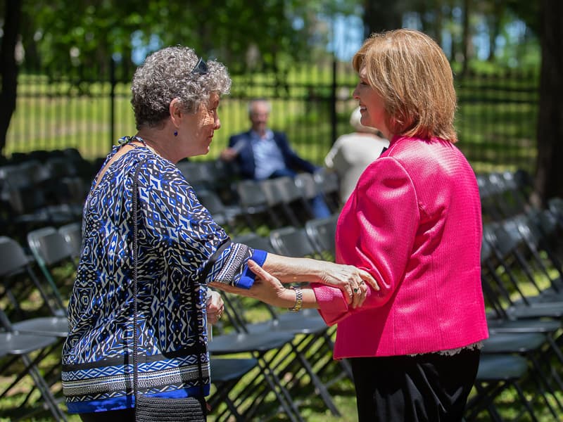 Following the ceremony, Jeanne Luckett of Jackson has a word with Dr. LouAnn Woodward, vice chancellor for health affairs and dean of the School of Medicine. Luckett attended the event to honor her brother, George Burnet of Walnut Grove.