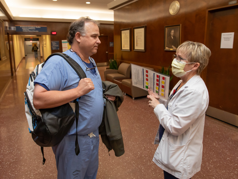 Infection preventionist Wendy Winn talks with anesthesiology CRNA Steven Wier about handwashing on World Hand Hygiene Day Thursday. Melanie Thortis/ UMMC Communications 