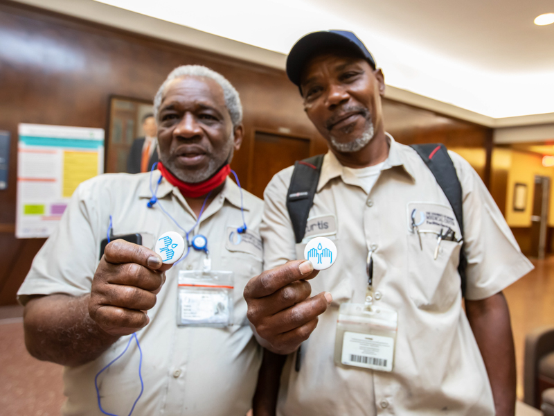 Machinery mechanic Tommy Nelson, left, and Power Plant boiler operator Curt Wilson show off their handwashing buttons.
