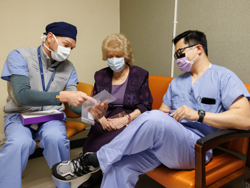 Dr. Michal Senitko, left, and Dr. Yanglin Guo talk to patient Elizabeth King of Lucedale before an outpatient procedure to install a custom-made silicone stent that will help open her airway. Joe Ellis/ UMMC Communications