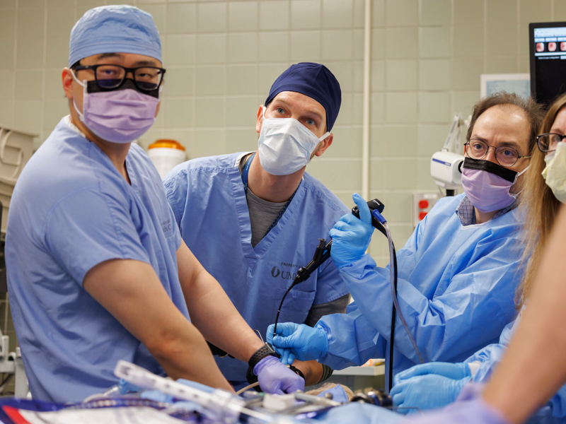 From left, Dr. Yanglin Guo, Dr. Michal Senitko and Dr. George Abraham look on a monitor to track the progress of equipment used to install Elizabeth King's silicone stent. Joe Ellis/ UMMC Communications 
