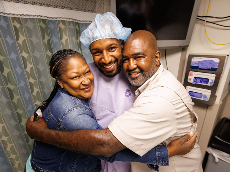 From left, Tawanna Davis, son Quinten Hogan and Hogan's stepdad, Spencer Davis, savor a group hug before Hogan was taken to surgery for removal of his left kidney to be donated to his mom.