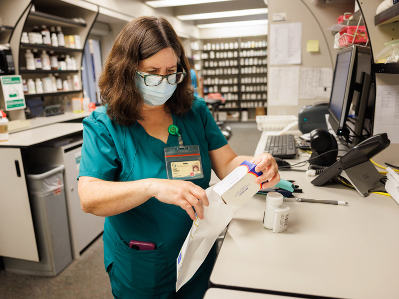 Pharmacist Grace Parmley bags COVID antiviral medications at the UMMC pharmacy located in the Pavilion. Joe Ellis/ UMMC Communications