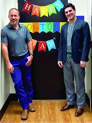 Dr Adam Byrd, left, and rural track dermatology resident, Dr. Joshua Ortego, are greeted in March with this message on National Doctors' Day 2022 at the dermatology clinic in Louisville. Ortego is about to spend another three months working at the clinic. (Photo courtesy of Dr. Adam Byrd)
