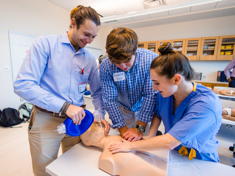 First-year medical students Darian Roucher, Andrew Roux, and Elizabeth White during first day basic life support training.