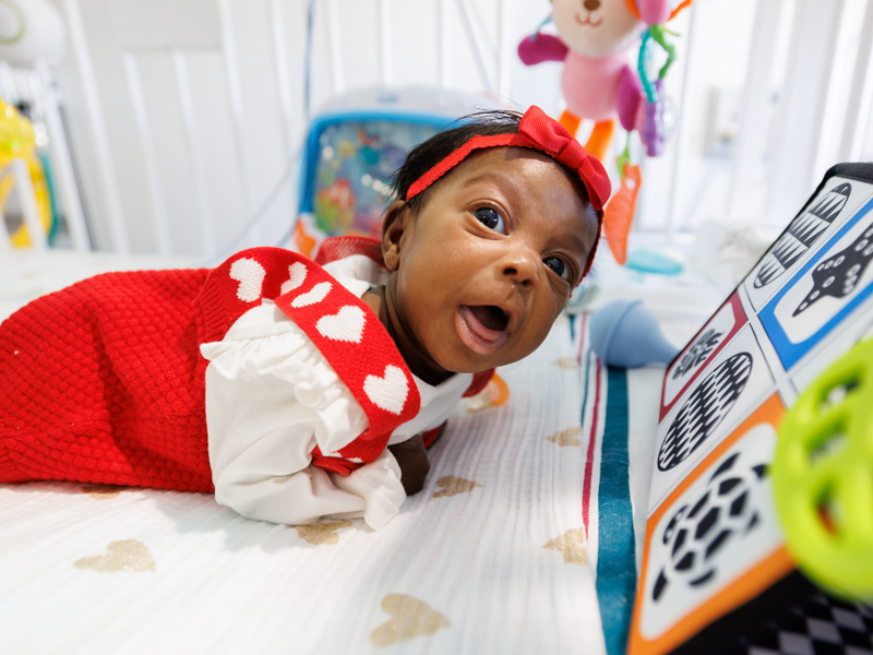 Londyn Logan, a 4-month-old born 5 weeks early at Children's Hospital, has tummy time with her occupational therapist therapist and early interventionist. Joe Ellis/ UMMC Communications 