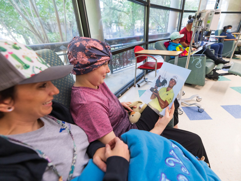 Sarah Garriga and daughter Joshlyn Necaise of Picayune smile after a visit with professional golfer Sam Burns at the Center for Cancer and Blood Disorders at Children's of Mississippi.