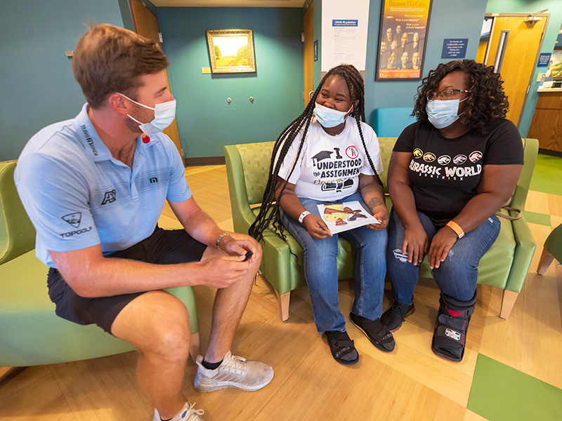 Burns talks with Children's of Mississippi patient Charnell Irby of Pachuta and her mom, Carolyn Bridges.