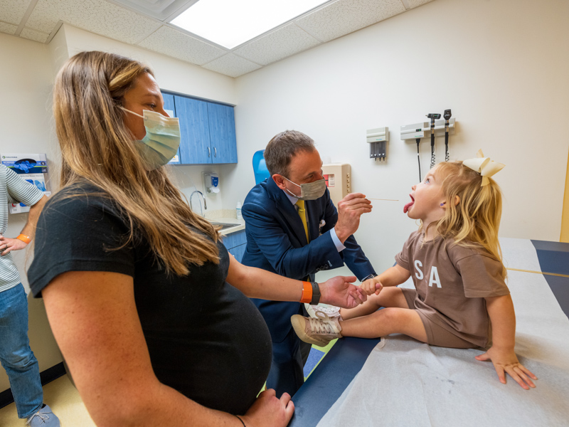 Dr. Ian Hoppe checks the palate of patient Isla Thrasher of Madison as her mom, Whitney Thrasher, looks on. Jay Ferchaud/ UMMC Communications 