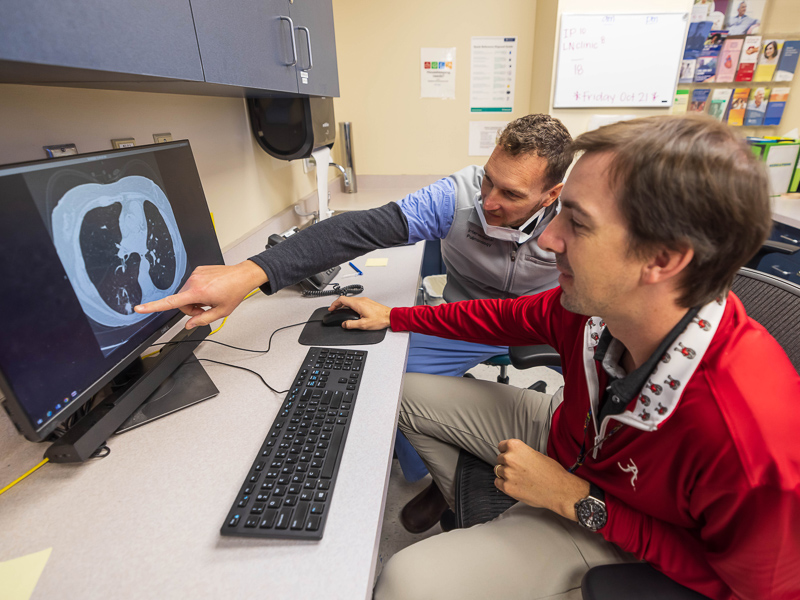 Nurse practitioner Jonathan Hontzas, right, co-director of UMMC’s thoracic oncology Lung Cancer Early Detection Program, and Dr. Michal Senitko, associate professor of pulmonary medicine, read the scan of a patient screened for lung cancer.