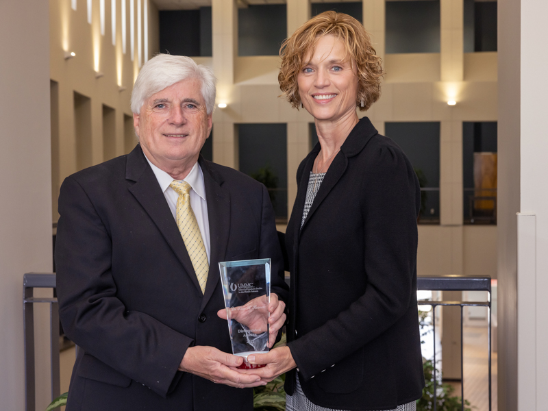 Dr. Joey Granger, associate vice chancellor for research and dean of the SGSHS, stands with Dr. Kim Hoover after presenting her with the Distinguished Alumna of the Year Award.