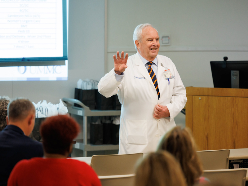 Dr. Michael Henderson addresses hospital leaders and his staff after his final Leadership Rounds, a program that takes leaders to the front line to hear their concerns and offer input.