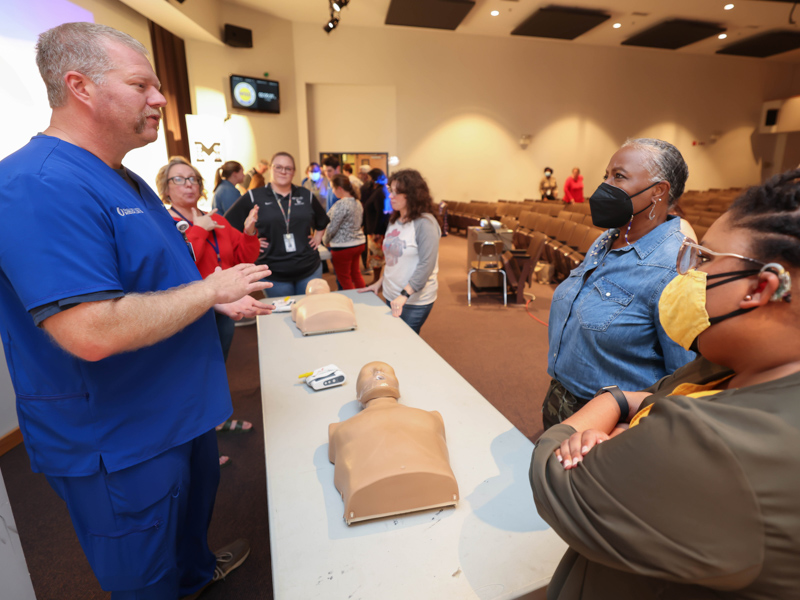 Jereme King tells Mississippi Schools for the Deaf and Blind faculty and staff including, from left, Kaci Cronin, Cassidy Holland, Mitzi Williams, Delois Stevenson and Crystal Newsome, how to perform CPR. Melanie Thortis/ UMMC Communications 
