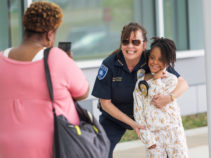 UMMC Chief of Police Mary Paradis lets patient Lori Webster of Natchez try on her badge while at the Mississippi Department of Public Safety Mardi Gras parade Tuesday. Melanie Thortis/ UMMC Communications 