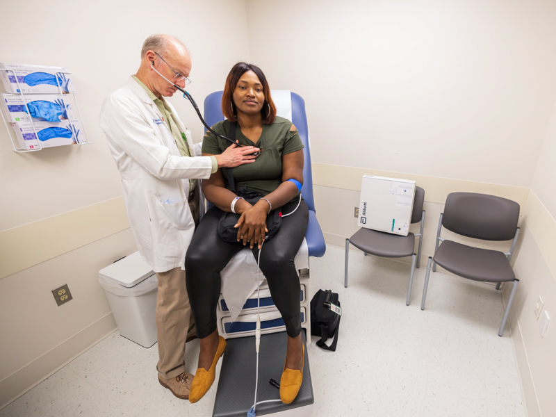 Cardiologist Dr. Charles Moore examines Sierra Garner, a left ventricular assist device patient, during a follow-up visit at the Advanced Heart Failure Clinic.