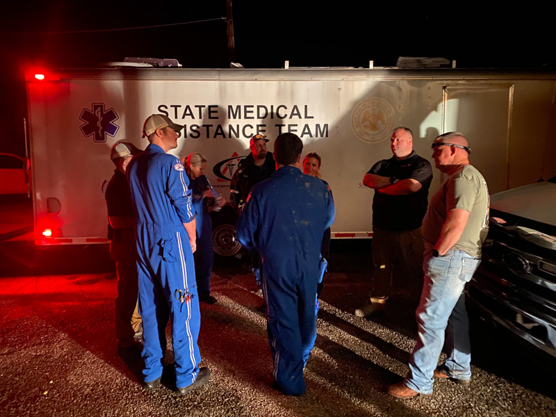 From left, Mississippi Center for Emergency Services emergency responders Chris Coleman, Brad Harper, Cori Bitner, Dustin Pope, Matt Greer, Kaci David, Jeremy Benson and Michael David lay plans for aiding storm victims at a command center in Rolling Fork.