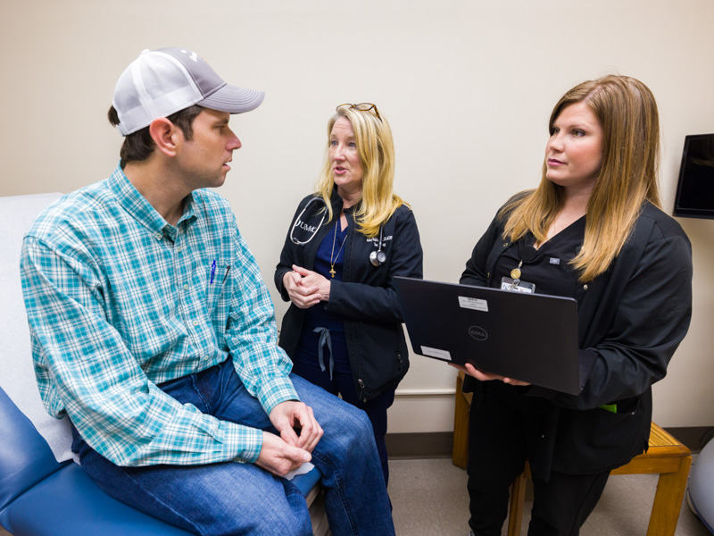 Transplant nurse practitioner Dr. Ashley Seawright, center, and registered nurse transplant coordinator Mallory Lester discuss follow-up care with kidney transplant recipient Walter Makamson of Greenwood.