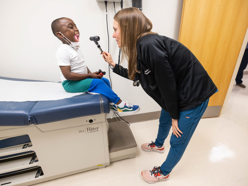 Children's of Mississippi nurse practitioner Hannah Jordan checks patient Kenson Young of Quitman, the first patient to be treated in the Center for Cancer and Blood Disorders' temporary location in Wiser Hospital for Women and Infants.