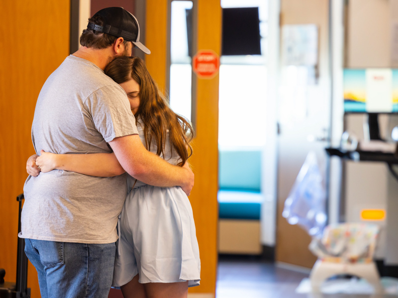 Shawn and Haylee Ladner embrace in the hallway of one of the two NICU floors of the Kathy and Joe Sanderson Tower.