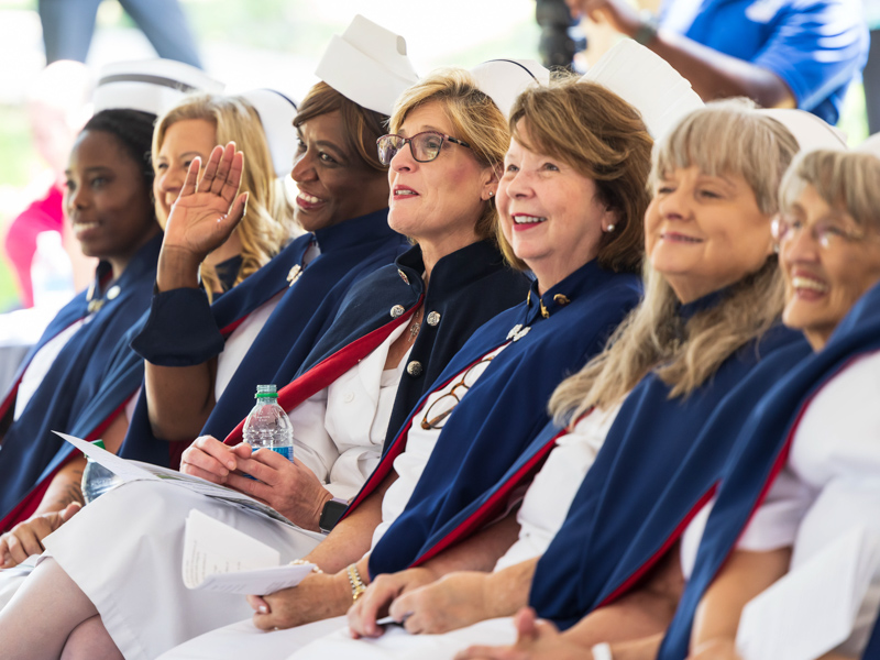 Mississippi Nurse Honor Guard member Margie Divinity, a retired nurse manager from UMMC, waves to guests during the School of Nursing groundbreaking ceremony. Melanie Thortis/ UMMC Communications 