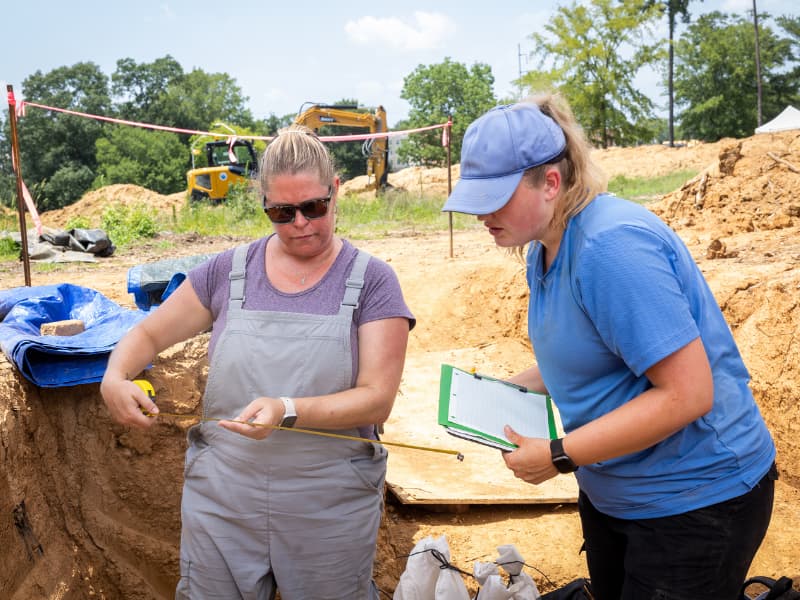 Becki Steele, left, a recent graduate of Randolph-Macon College in Virginia, and Mollie Morgan, a Mississippi State University graduate student, make some calculations with a tape measure. Jay Ferchaud/ UMMC Communications