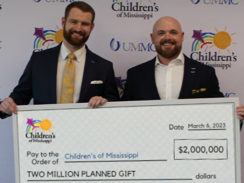 Gates P. Willson, left, and Chase Patrizzi of Patrizzi & Willson Financial Group show their $2 million planned gift to Children's of Mississippi.