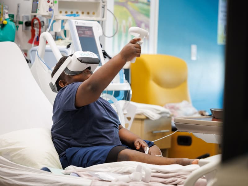 Children's of Mississippi patient Malekhi Smith is immersed in a virtual reality game.