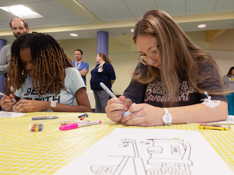 Children's of Mississippi patients Melanie Conner of Clinton and Makayla Jones of Moss Point decorate golf balls during a Sanderson Farms Championship afternoon at the children's hospital. This year's tournament is set for Oct. 2-8 at the Country Club of Jackson.