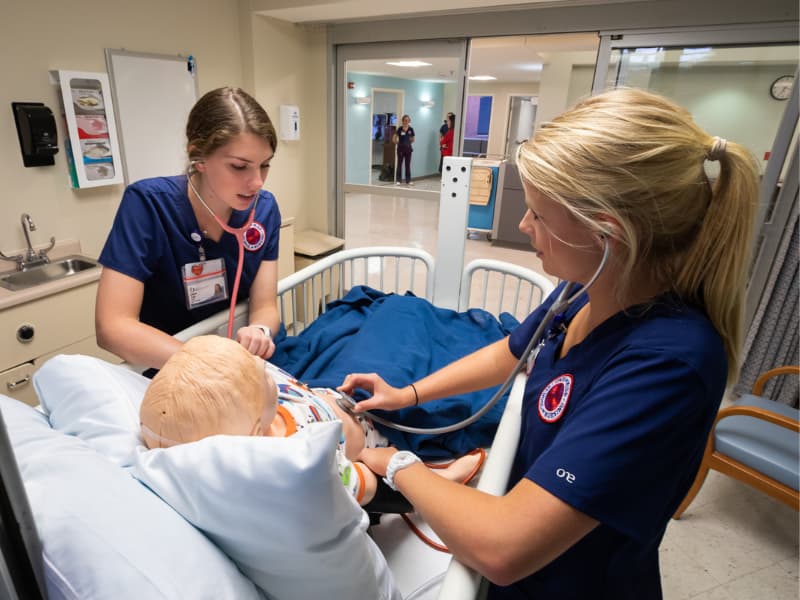 In this 2019 photo, School of Nursing students Katherine Cradic, left, and Mary Carson Lynch perform record vital signs in a simulation lab at the South Oxford Center.