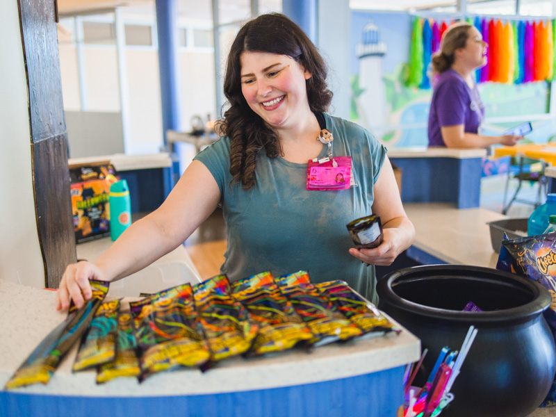 Child life specialist Kelsey Clark sets out glow sticks and snacks for patients to enjoy during a movie matinee.