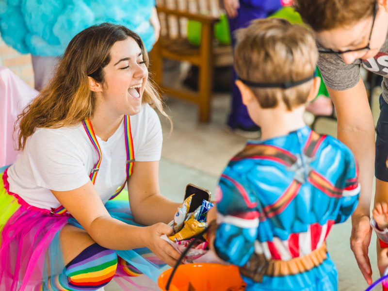First-year medical student Lexi Lomax offers treats to costumed kids at Spooky U.