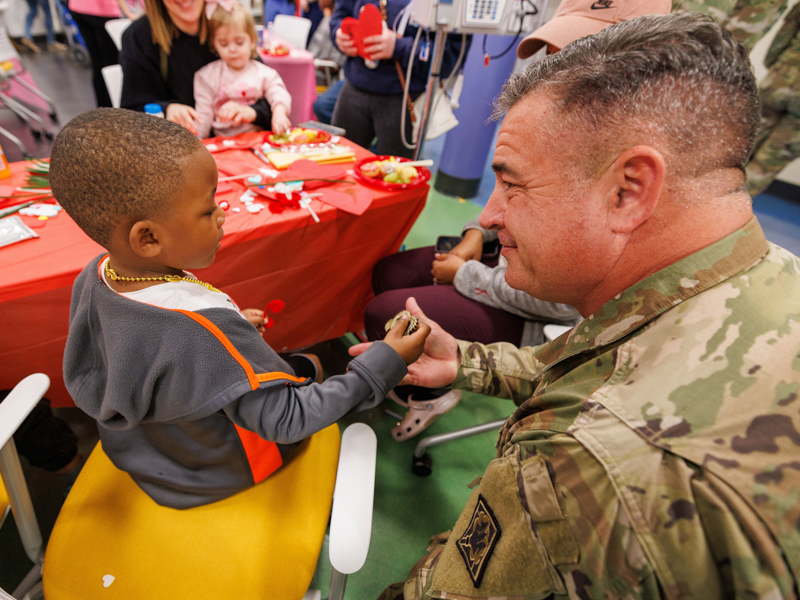 Children's of Mississippi patient Telvin Holmes Jr. of Liberty receives a pin from Command Chief Warrant Officer Donny Dukes. Jay Ferchaud/ UMMC Photography 