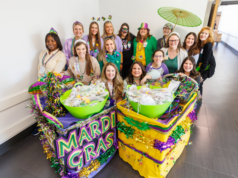 Bringing Mardi Gras fun to Children's of Mississippi patients are members of Friends of Children's Hospital and the children's hospital's child life team. Melanie Thortis/ UMMC Photography 