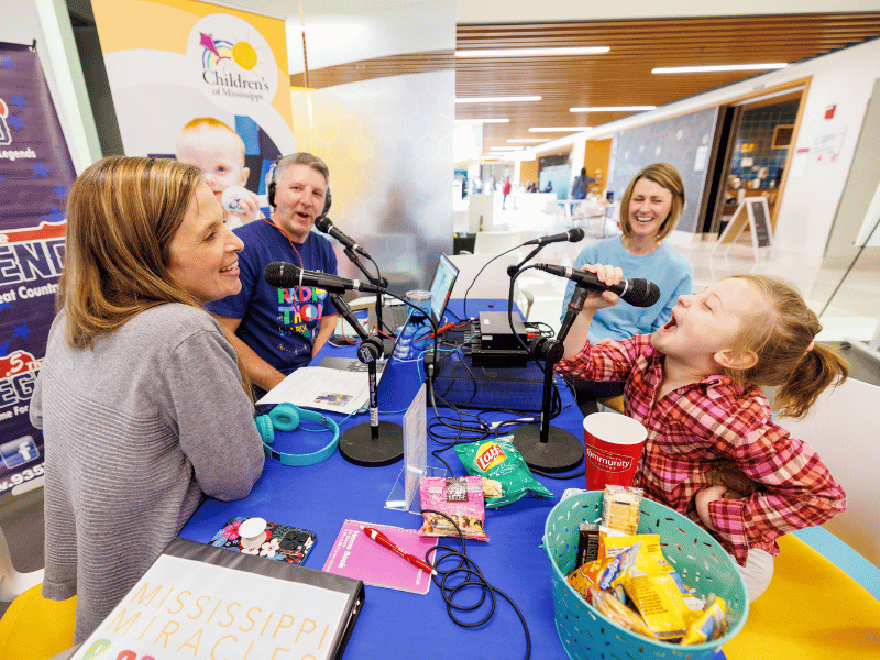 Children's of Mississippi patient Mary Mosley Pickering belts out a Taylor Swift tune during Mississippi Miracles Radiothon. Jay Ferchaud/ UMMC Photography