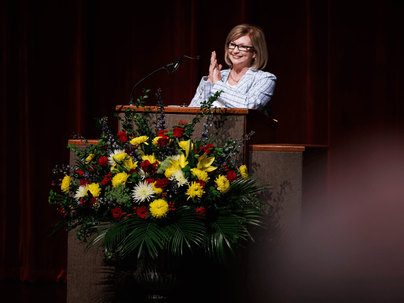 Dr. LouAnn Woodward, vice chancellor for health affairs and dean of the School of Medicine, applauds students' matches during the annual Match Day ceremony. Melanie Thortis/ UMMC Photography