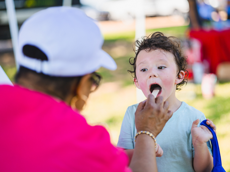 Dr. Teresa Perkins checks Dalton Karnitz's teeth during a dental screening at Children's of Mississippi's Back-to-School Health Rally.