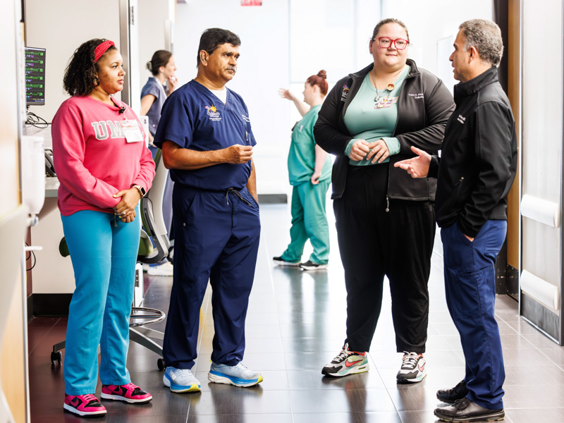 Discussing research findings are, from left, Chelsea Giachelli, clinical research coordinator; Dr. Abhay Bhatt, director of research in the Division of Neonatology; Dr. Taylor Mayes, resident, and Dr. Simon Karam, associate professor of neonatology.