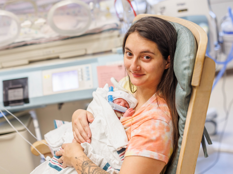 Ashley Meyers cradles daughter Nova Mae during a visit with her quintuplets.