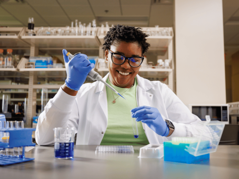 Ariel Cox, a researcher in psychiatry, works with equipment in the Translational Research Center.