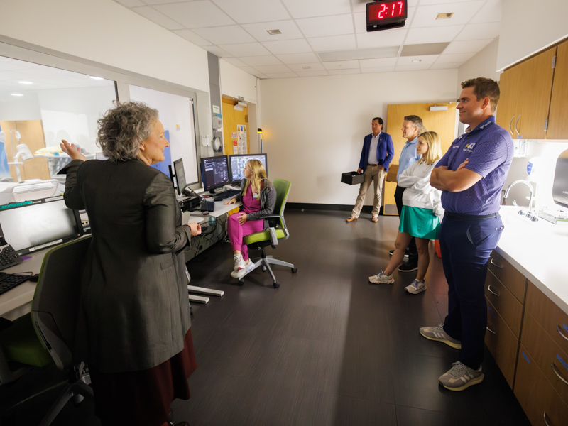 Ellen Hansen, Children's of Mississippi chief operations officer and chief nursing officer, gives 2023 Sanderson Farms Championship winner Luke List a tour of pediatric imaging areas in the Kathy and Joe Sanderson Tower.