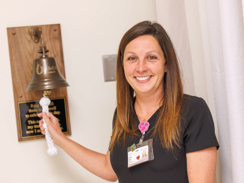 Registered Nurse Jessica Greer is all smiles after ringing the cancer bell at UMMC Grenada.