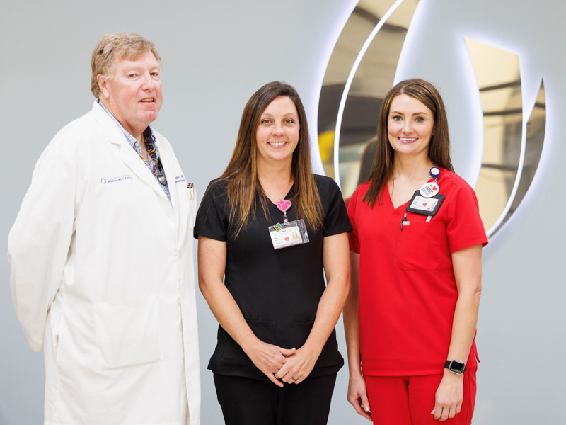 Associate Professor of Medicine and Medical Oncologist Dr. Dennis "Bubba" Morgan, Registered Nurse Jessica Greer and Hematology/Oncology Nurse Practitioner Kayla Moore