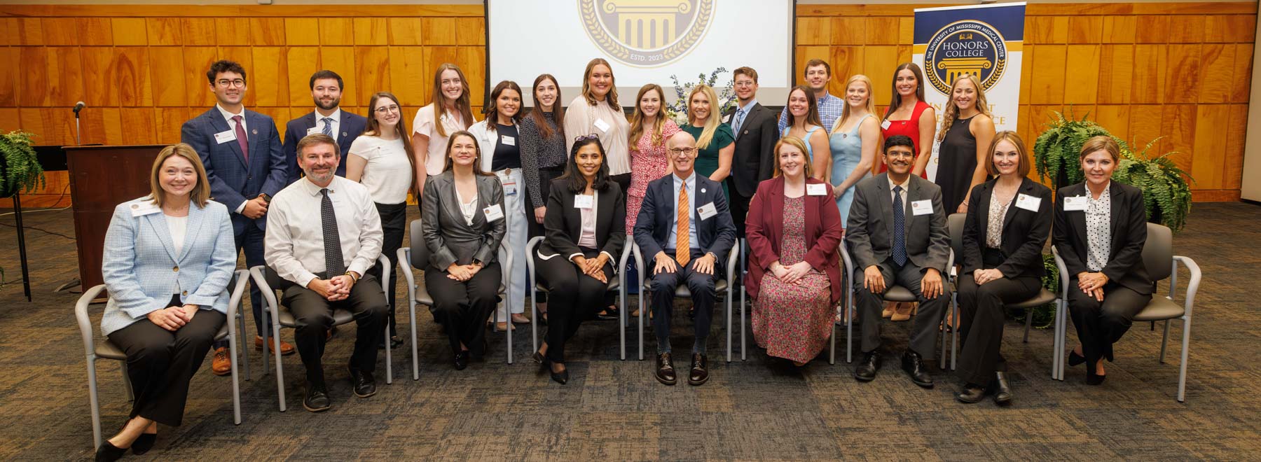 Faculty members and leaders of the UMMC Honors College are, front row, from left, Dr. Natalie Gaughf, assistant vice chancellor for academic affairs; Dr. Danny Burgess, associate professor of psychiatry; Dr. Josie Bidwell, associate professor of preventive medicine and director of the Office of Well-being; Dr. Victoria Gholar, assistant dean for student affairs in the John D. Bower School of Population Health; Dr. Scott Rodgers, associate vice chancellor for academic affairs and chief academic officer; Dr. Elizabeth Hinton, associate professor and director of the Rowland Medical Library; Dr. Amol Janorkar, professor and chair of biomedical materials science in the School of Dentistry; Dr. Elizabeth Carr, professor and chair of dental hygiene in the School of Dentistry; and Dr. Penni Foster, interim chief student affairs officer and leader of the UMMC Honors College. Student inductees are, back row, from left, Tyler Thibert, Daniel Young, Crislyn Cole, Abbey McCrory, Payton Ryals, Alexandra Wolfe, Kaitlyn Quick, Sarah Davis Baker, Olivia Jennings Austin, Kaleb Thompson, Madison Beets, Luke Alexander, Madelaine Palen, Katlyn Garner and Riley Huckaby.