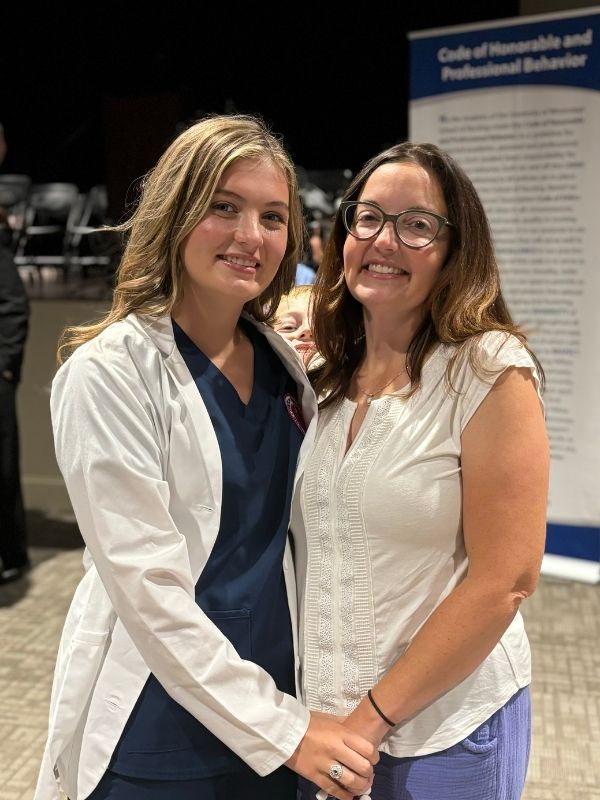 Baldwin smiles with her mother, Jennifer Leigh Greer, after earning her white coat at the UMMC School of Nursing.